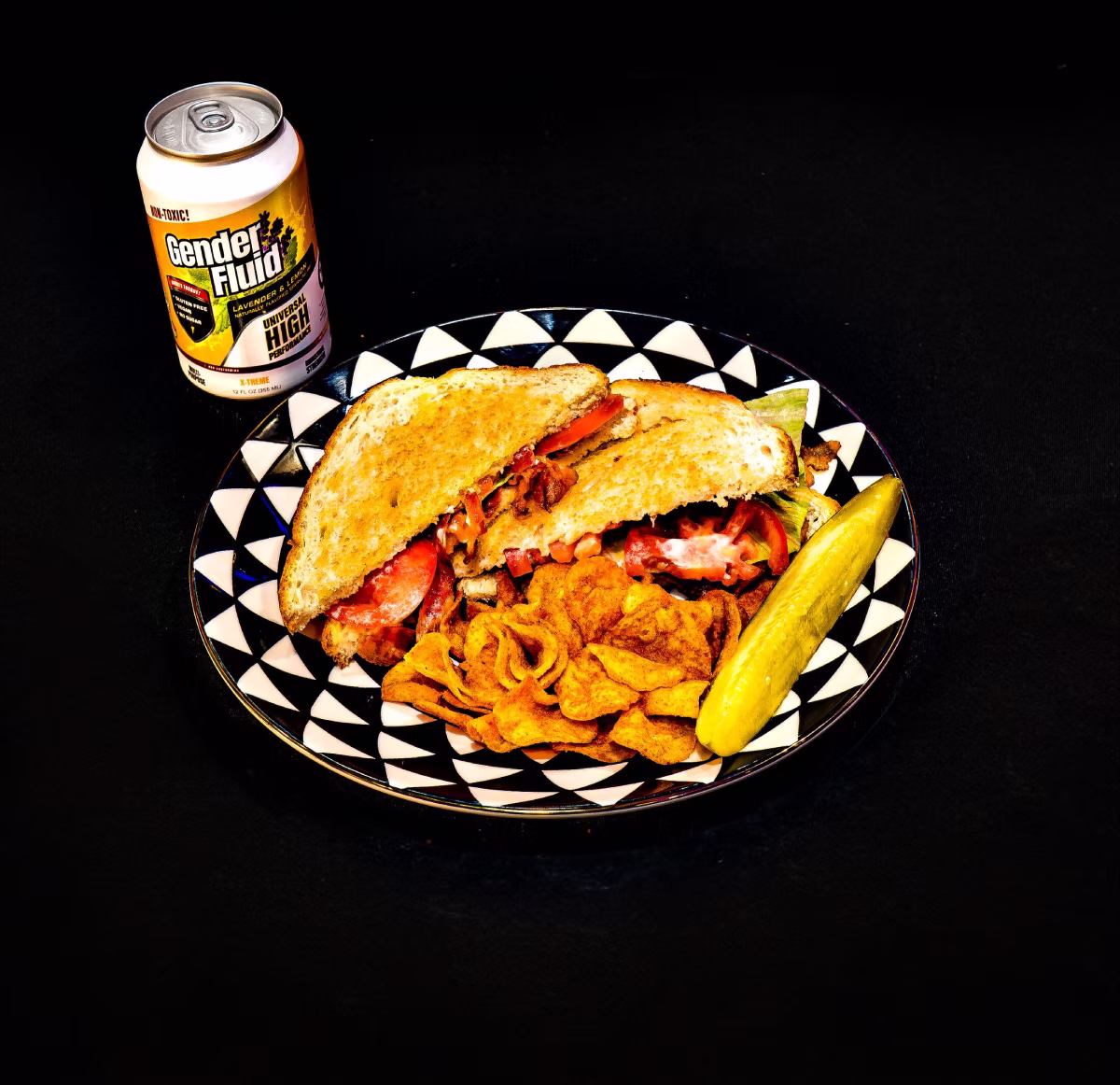 A sandwich, chips pickle and drink at Meow Wolf Grapevine cafe
