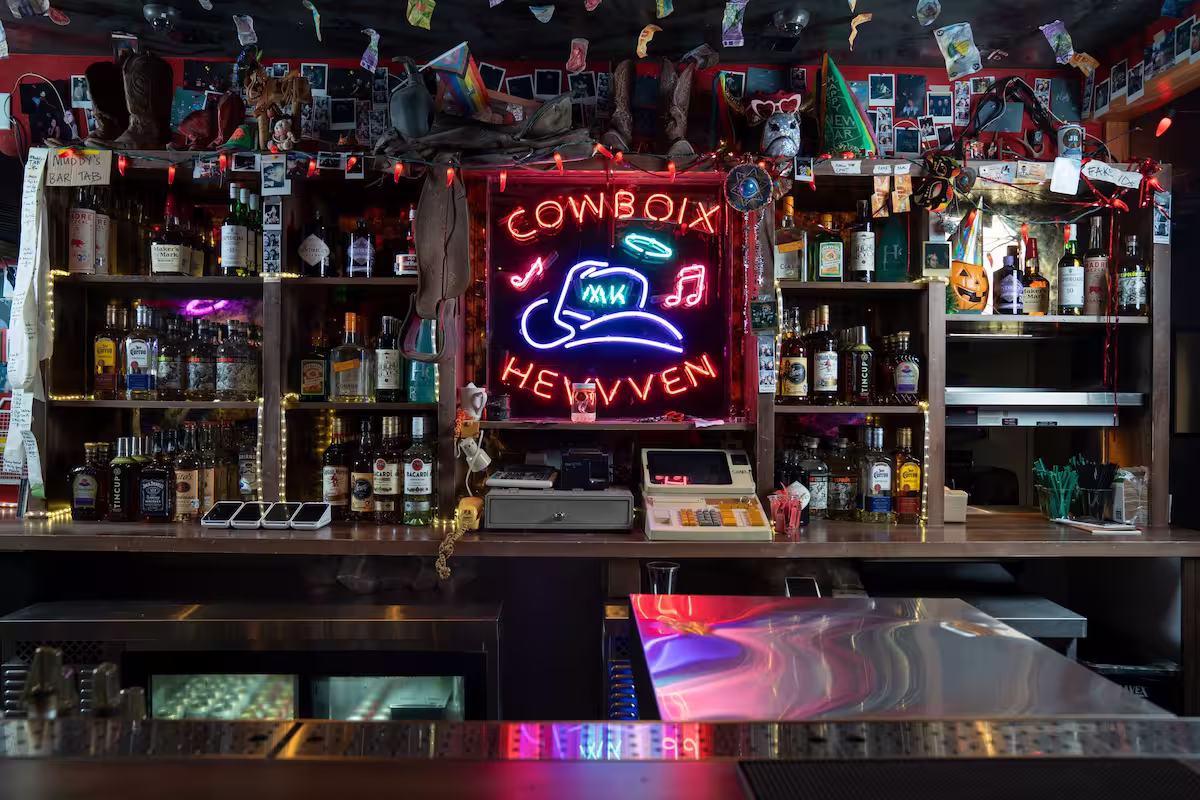 bar space with a neon sign that reads Cowboix Hevvven"