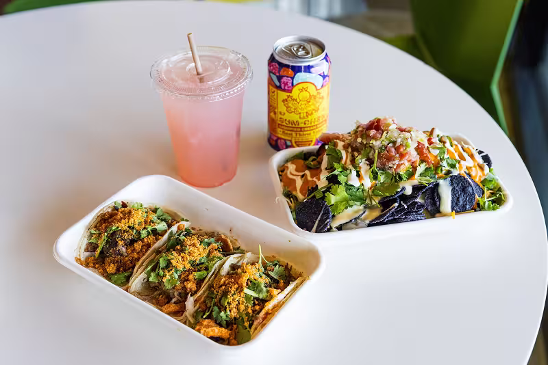 tacos and drinks on a white table